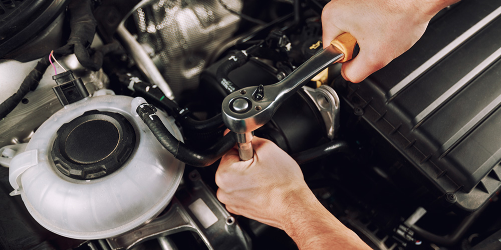 Image of Mechanic Fixing Engine
